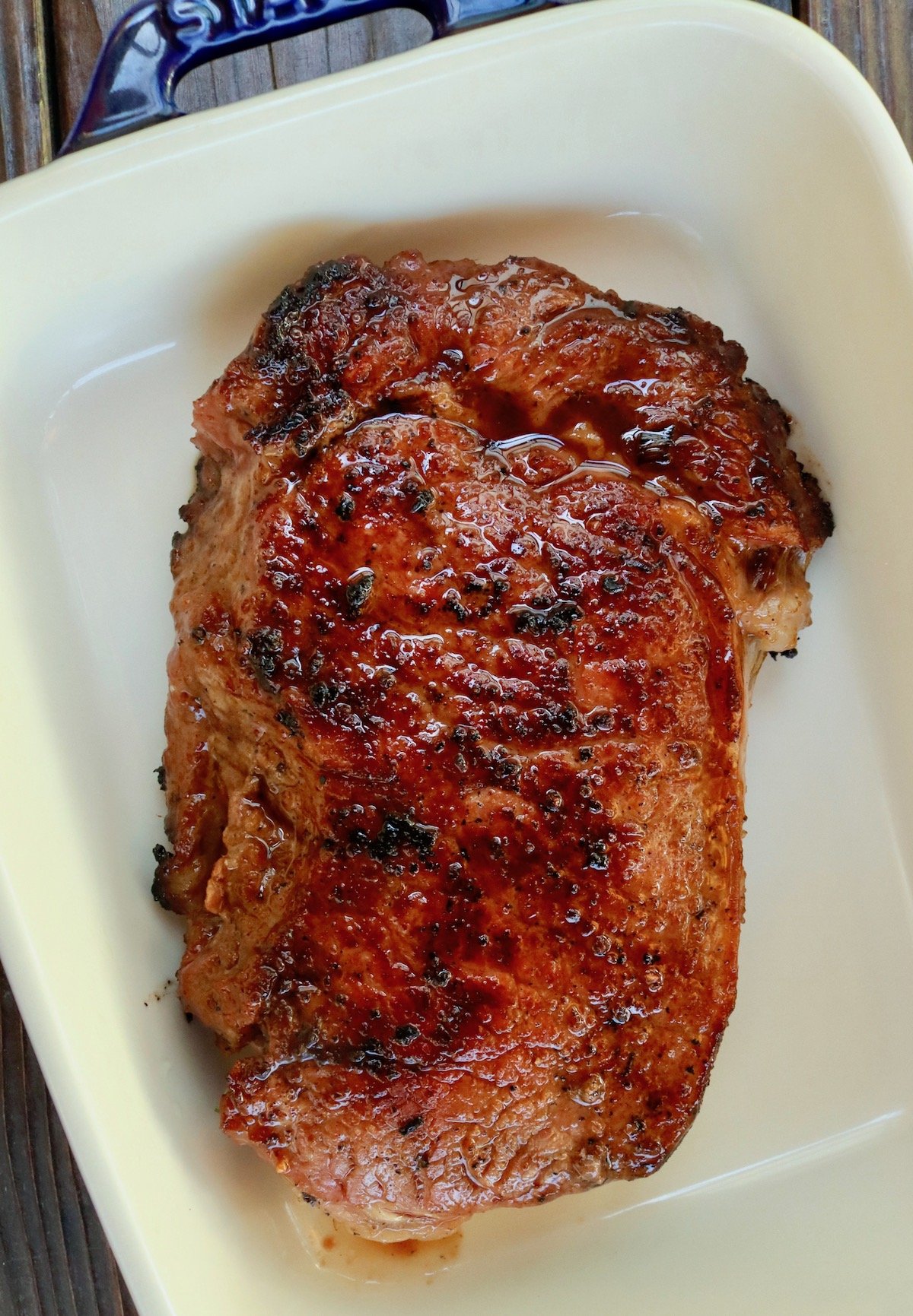 seared rib-eye steak in baking dish