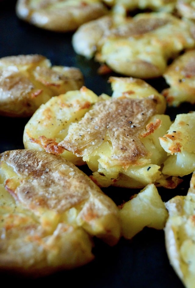 Sheet pan full of golden, crispy smashed potatoes