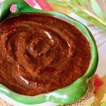 Green-rimmed bowl with Ancho chile sauce.