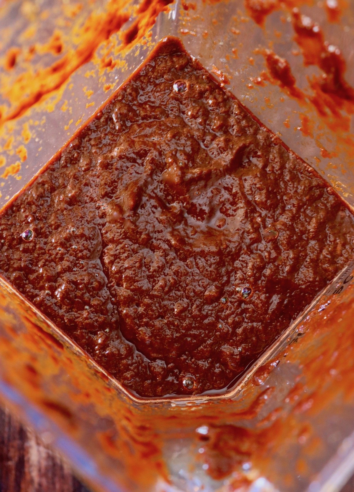 Top view of blender with ancho chile sauce blended.