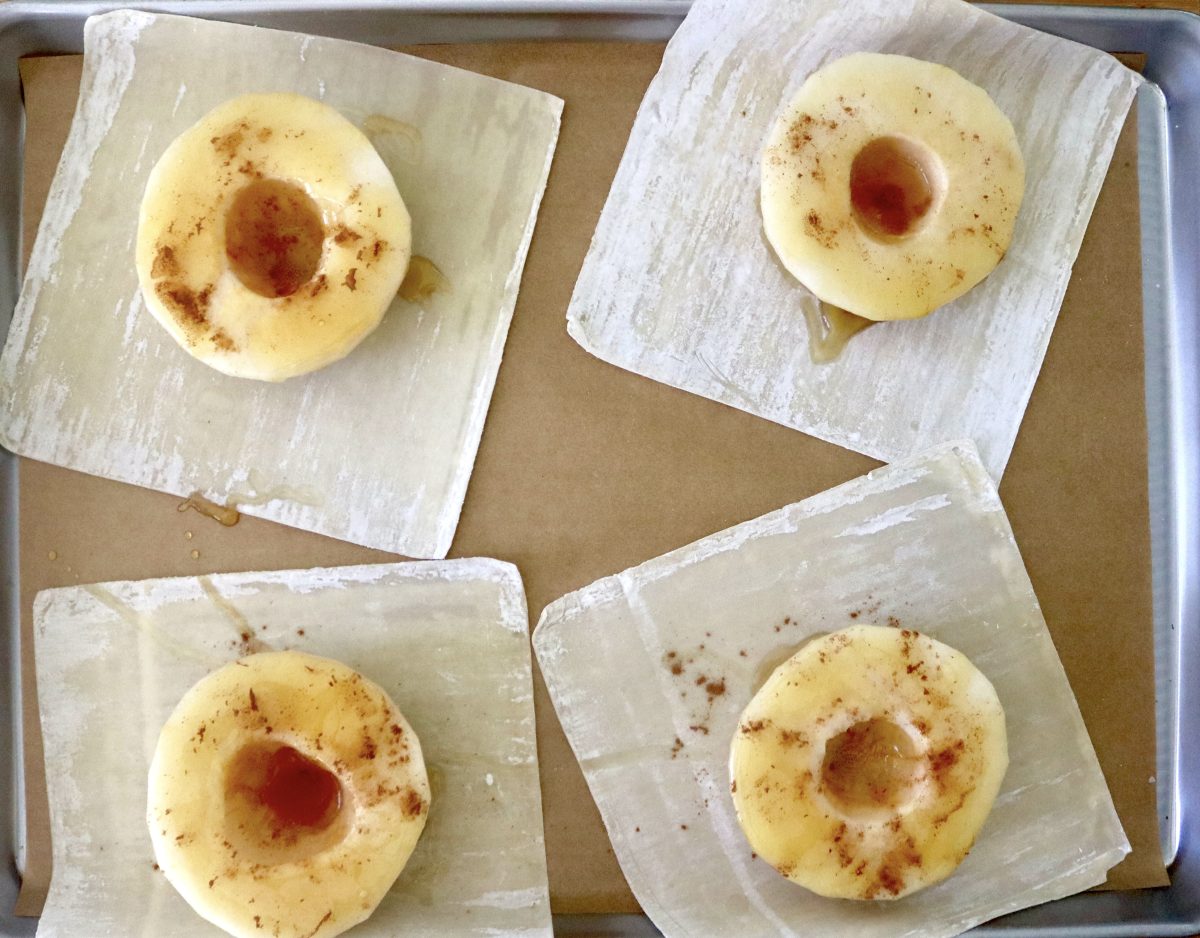 Baked-Asian-Pear-Recipe Four Asian pear halves with the seeds removed, on top of wonton wrappers, sprinkled with cinnamon and drizzled with honey.