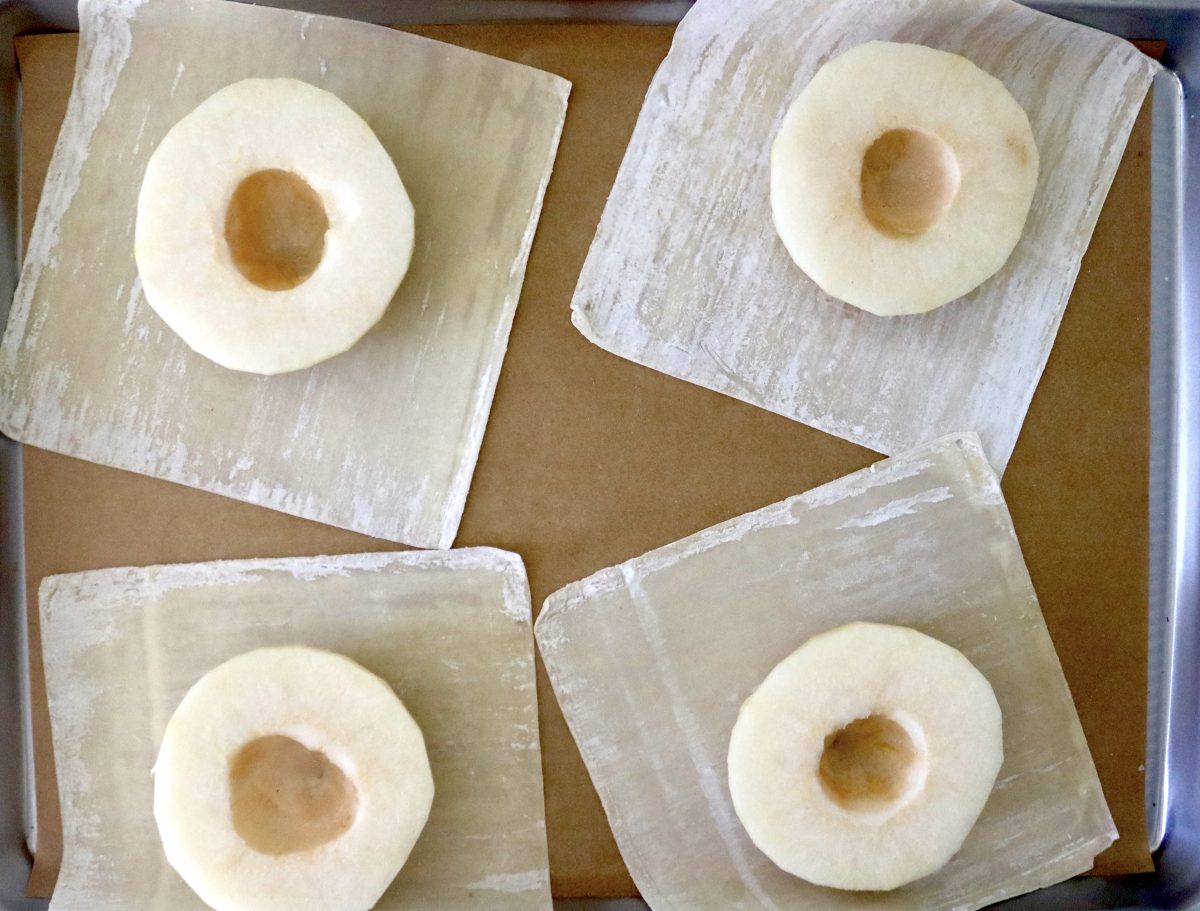 Baked-Asian-Pear-Recipe Four Asian pear halves with the seeds removed, on top of wonton wrappers, on parchment-lined baking sheet.