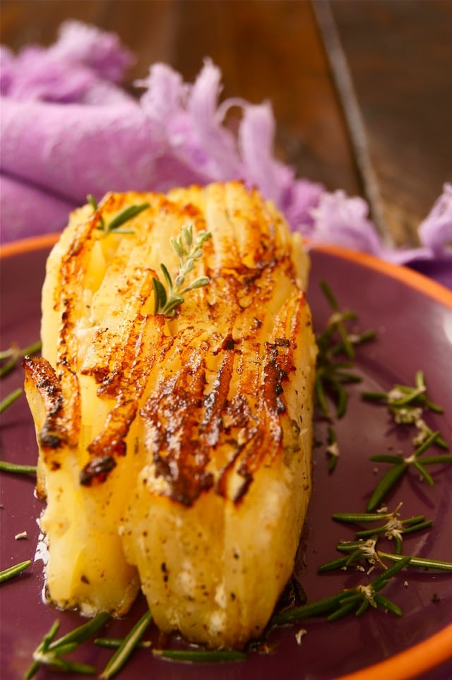 On slice of Potato Pave with Rosemary on a purple plate