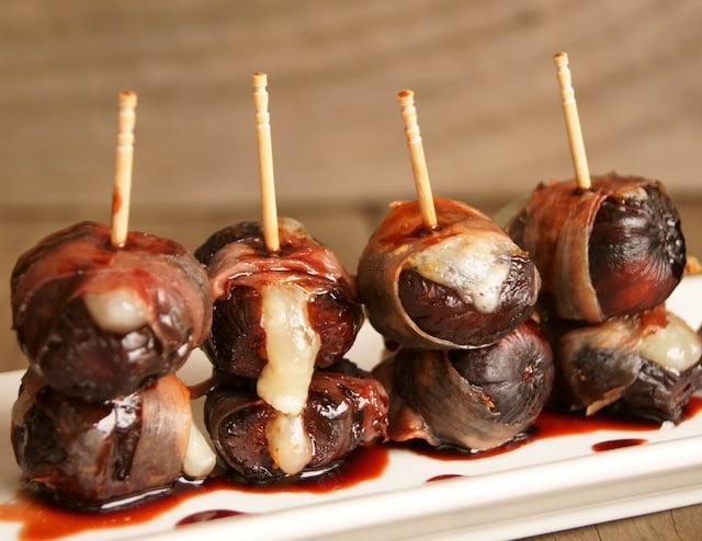 4 Port Glazed Figs, Manchego and Prosciutto Hors d'Oeuvres with a toothpick in each one.