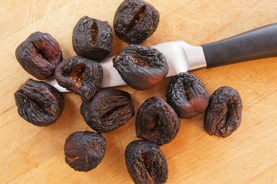 Dried figs with a paring knife.