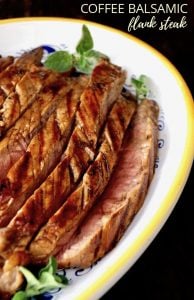 Large yellow-rimmed white platter filled with slices or grilled coffee balsamic flank steak.