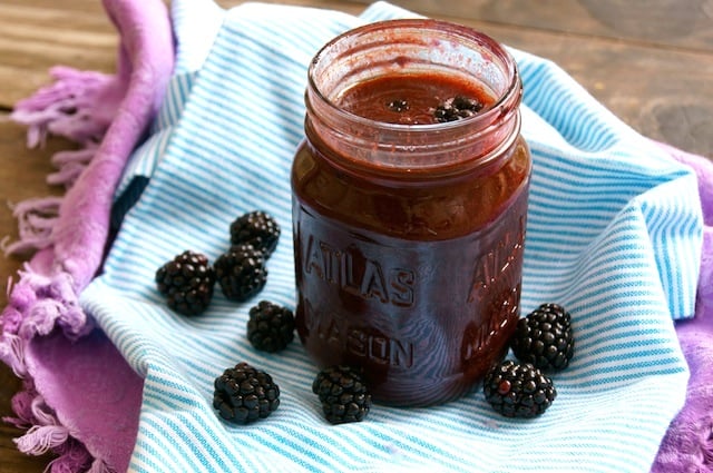 Blackberry Balsamic Vinaigrette in a Mason jar surrounded with fresh blackberries