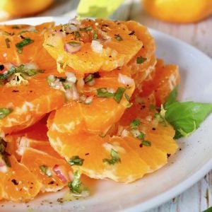 close up of white plate full with round slices of Satsumas