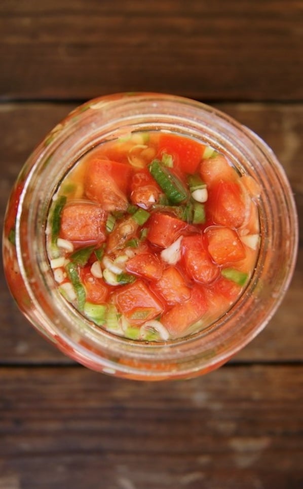 Top view of pickled Tomatoes Recipe in an open jar.