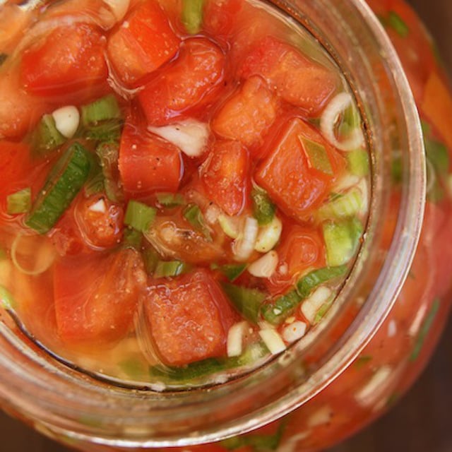 top view of jar of pickled tomatotes