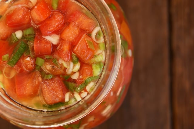 Top view of Pickled Tomatoes in a jar for Pickled Tomato-Pulled Pork Tacos.