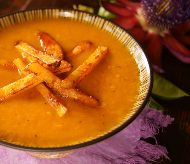 Roasted Pepper Potato Soup with Smoky Chipotle Parmesan French Fries in a black-rimmed bowl