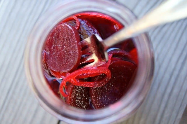 jar of pickled beets with a fork