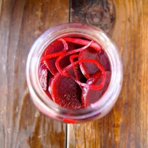 top view of a mason jar with pickled beets and onion