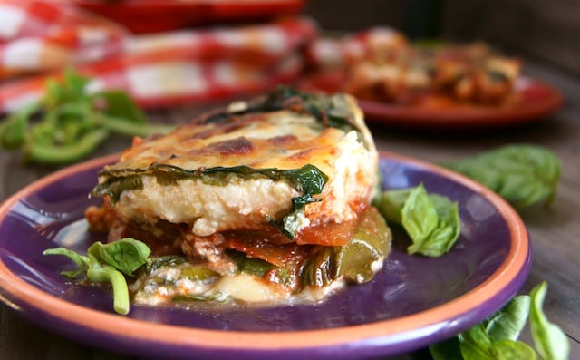 One slice of gluten-free, vegetarian Swiss Chard Lasagna on a purple plate.