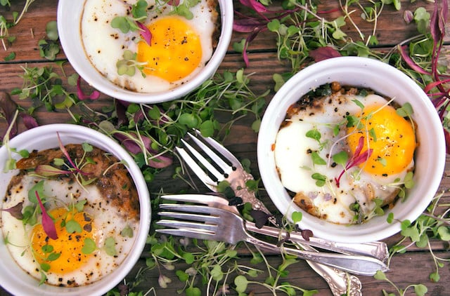 three white ramekins with hash browns and eggs