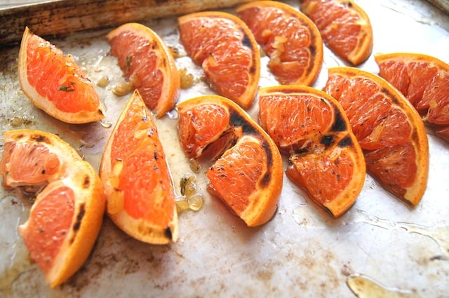 Broiled Grapefruit slices on a baking sheet