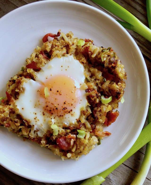 One slice of bacon hash brown casserole with a sunny side up egg