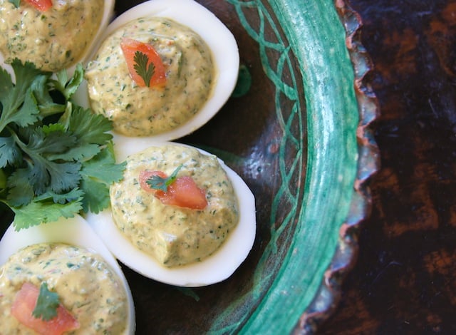 Close up of Spicy Cilantro Deviled Eggs in a green bowl