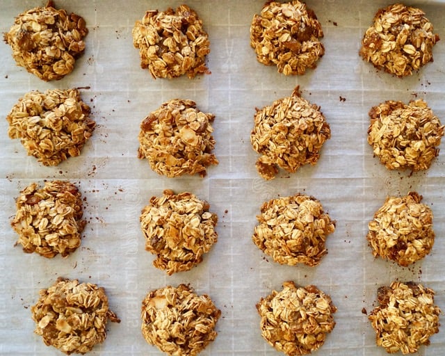 sheet pan with parchment paper and baked, spiced breakfast granola cookies.