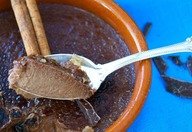 Mexican Chocolate Creme Brulee in a terra cotta rameking with one bite in a teaspoon