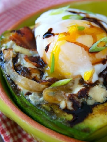 grilled avocado with onion and poached egg on top