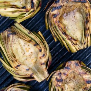Halved artichokes grilled on the grill.