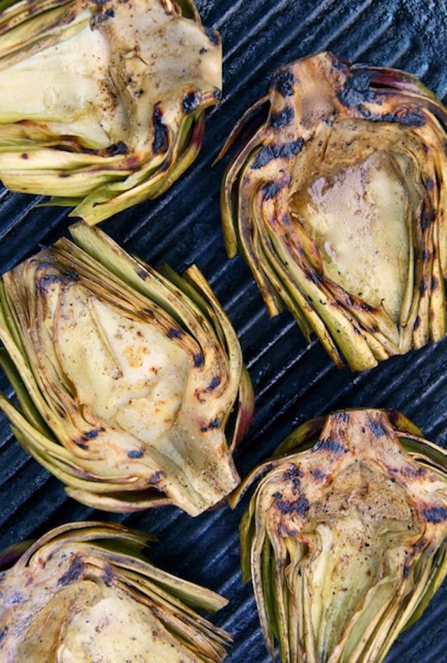 Grilled artichoke halves on a grill