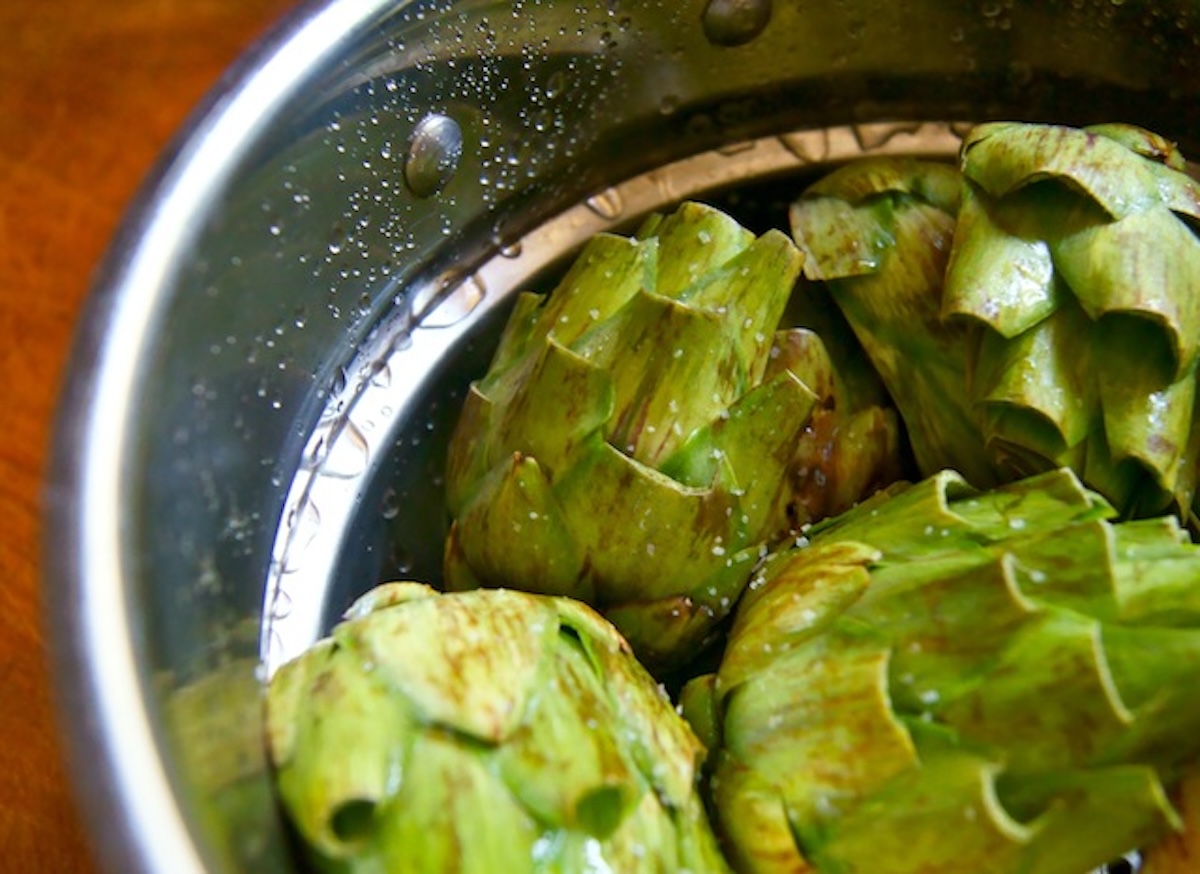 How-to-Grill-Artichokes (Smoky and Tender) Artichokes in steamer pot.