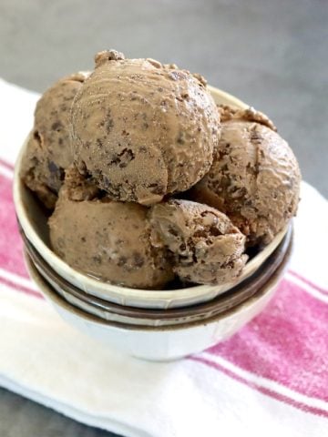 A few scoops of Espresso Gelato with Kahlua in a cream-colored bowl with two bowls below it.