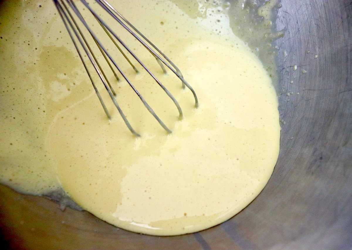 Egg yolk and sugar mixture with a whisk.