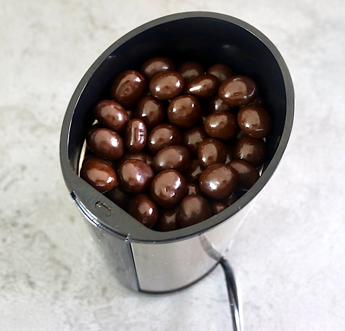 Chocolate covered espresso beans in a spice/coffee grinder.