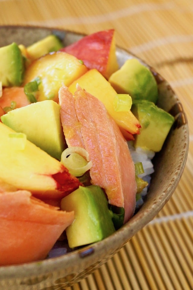 close up of Sockeye Salmon Recipe with Peach and Avocado in ceramic bowl on sushi mat