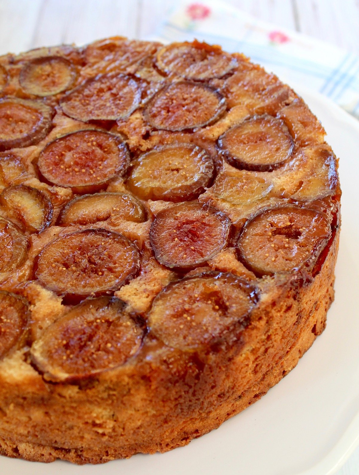 top of upside down fig coffee cake on a white platter
