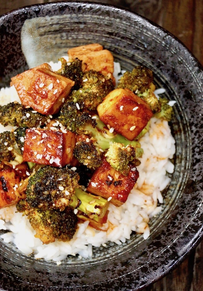  Sesame Sriracha Honey Glazed Tofu Broccoli over white rice in a black. bowl.