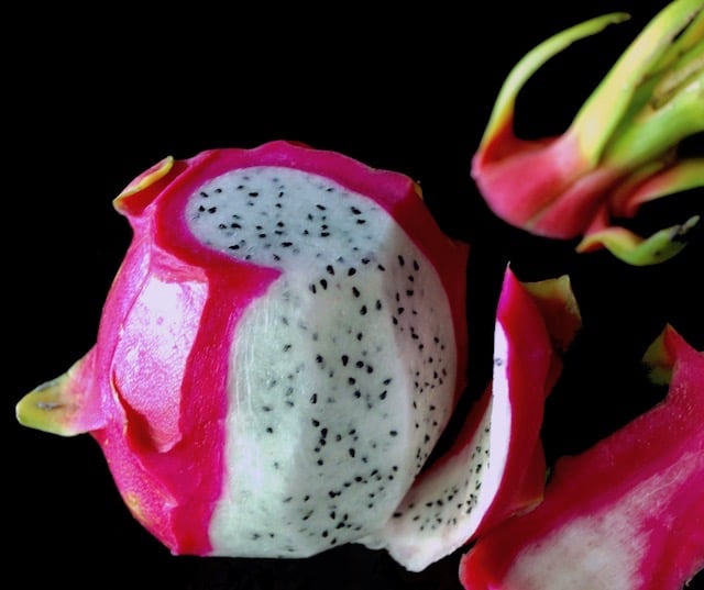 Magenta and white Dragon Fruit partially peeled.