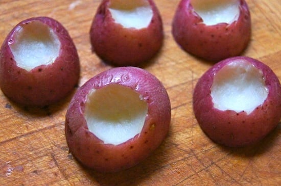 Pee wee red potatoes with the centers scooped out.