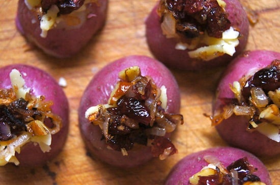 Mini red potatoes with caramelized onions on cutting board 