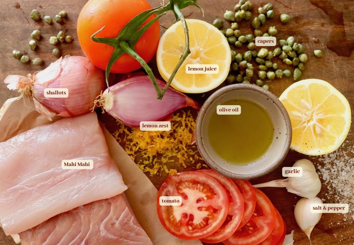 Ingredients for mahi mahi recipe including lemons, olive oil, tomatoes, capers and shallots.