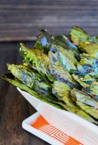 bok choy chips in square white dish with chili flakes