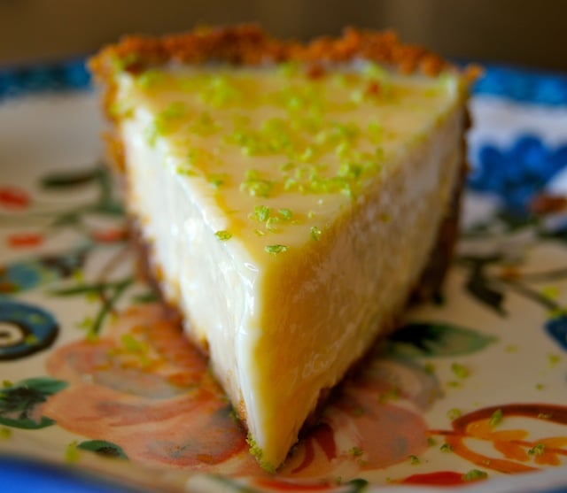 One slice of Citrus Ginger Pie on floral ceramic plate with a blue rim.