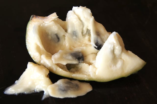 Cherimoya slice with a few seeds next to it