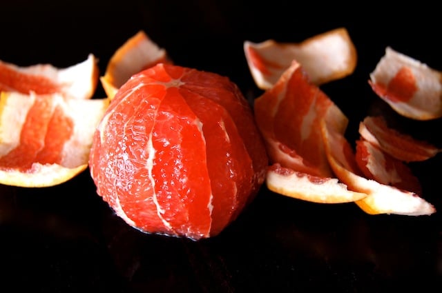 peeled grapefruit with skins around it