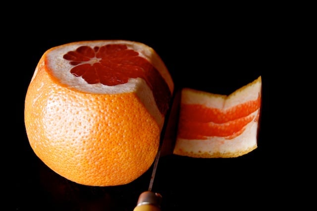 grapefruit with skin being cut off