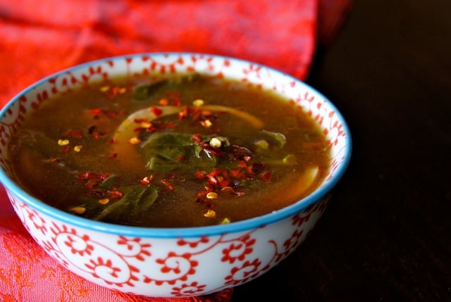 Gai Lan Soup Recipe with Egg in a red and shite patterned bowl.