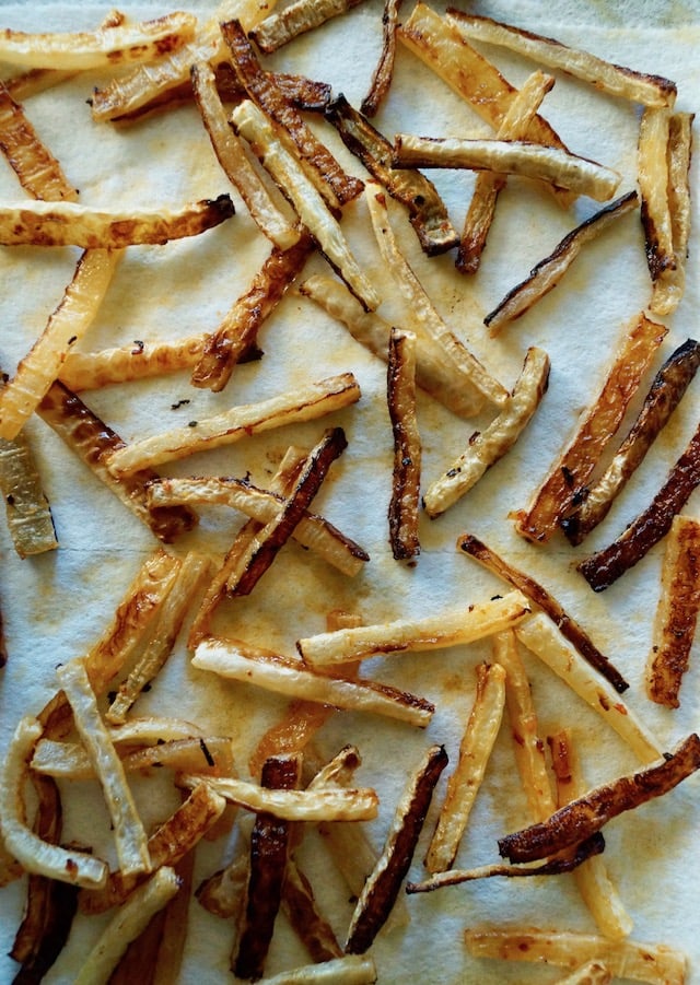 Spicy RoastedA pile of Daikon Radish French Fries on parchment paper.