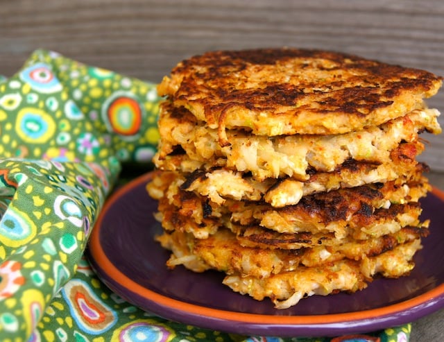 Several Spicy Cabbage Potato Pancakes stacked on a purple plate