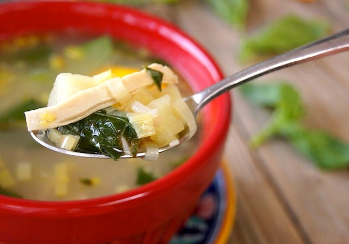 Kotosoupa-Augolemono-Recipe Kotosoupa Avgolemono Recipe in red bowl with one bit in a spoon.