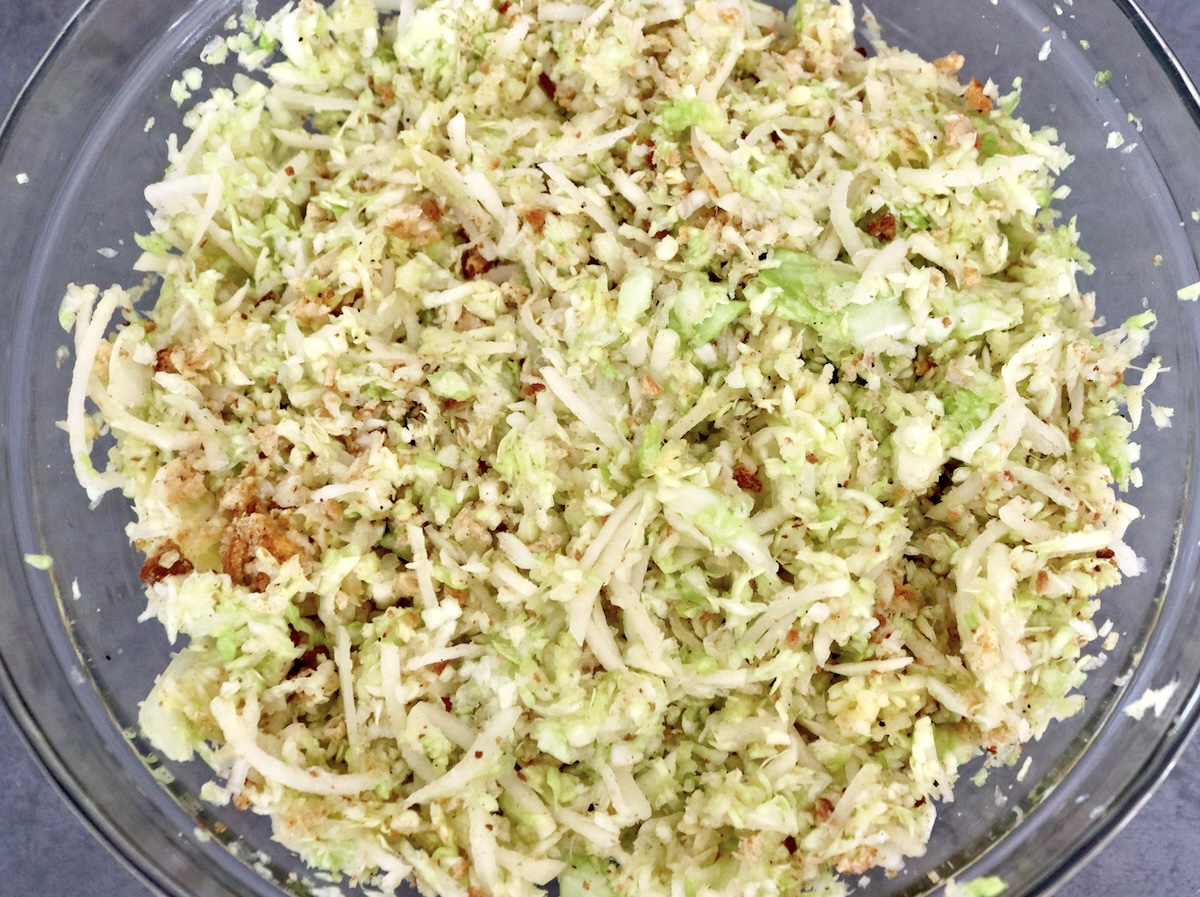 Cabbage-Potato-Pancakes Large glass bowl with mixture of grated cabbage, potatoes, breadcrumbs and eggs.