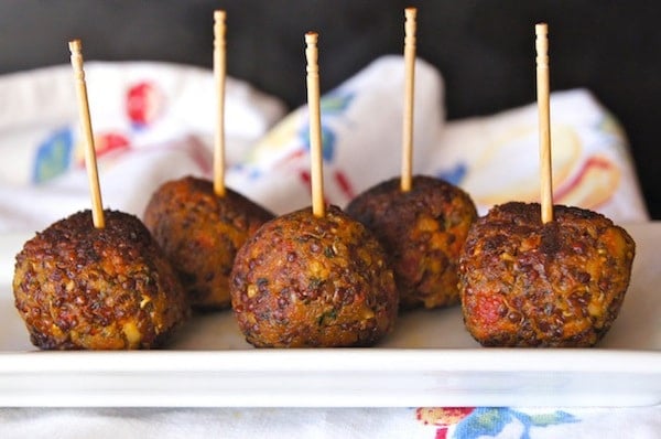 Spicy Red Quinoa Bites with toothpicks on long whtie plate